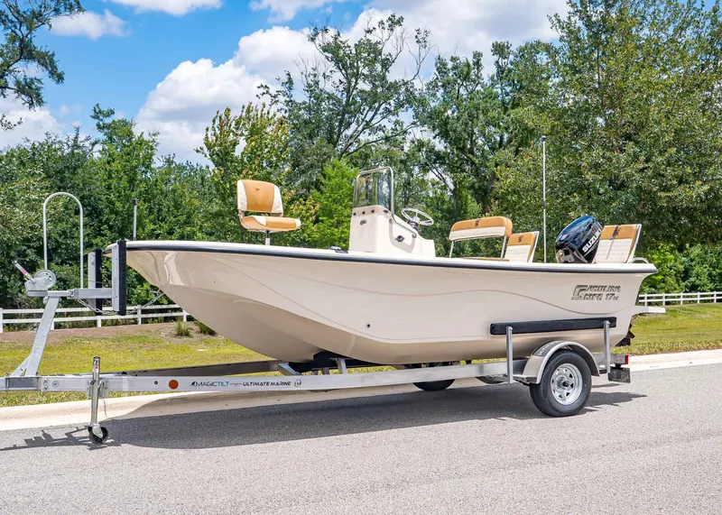 The Image of 2026 Carolina Skiff 17 LS boat on trailer, sunny day. - 1