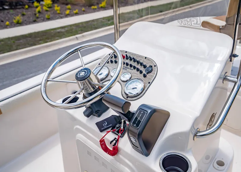 Slide: The Image of Carolina Skiff 17 LS 2026 helm with gauges and controls. - 17