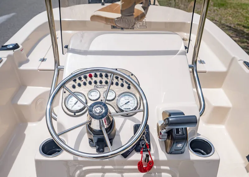 Slide: The Image of 2026 Carolina Skiff 17 LS helm with gauges and controls. - 18
