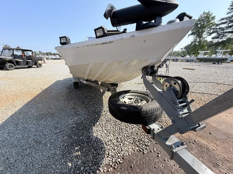 Slide: The Image of 2016 Alweld Marsh Console boat on trailer, gravel lot. - 4