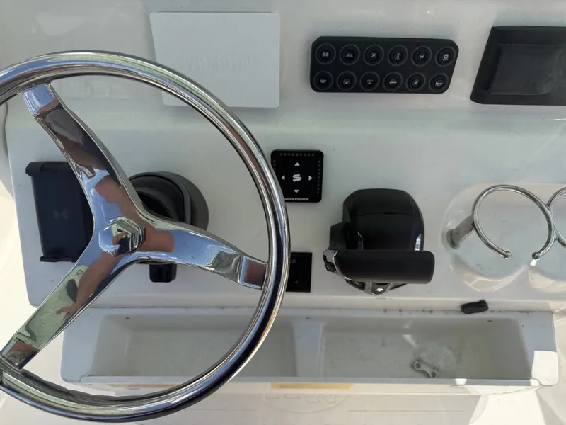 Slide: The Image of Key West 239 FSR 2026 helm with steering wheel and controls. - 14