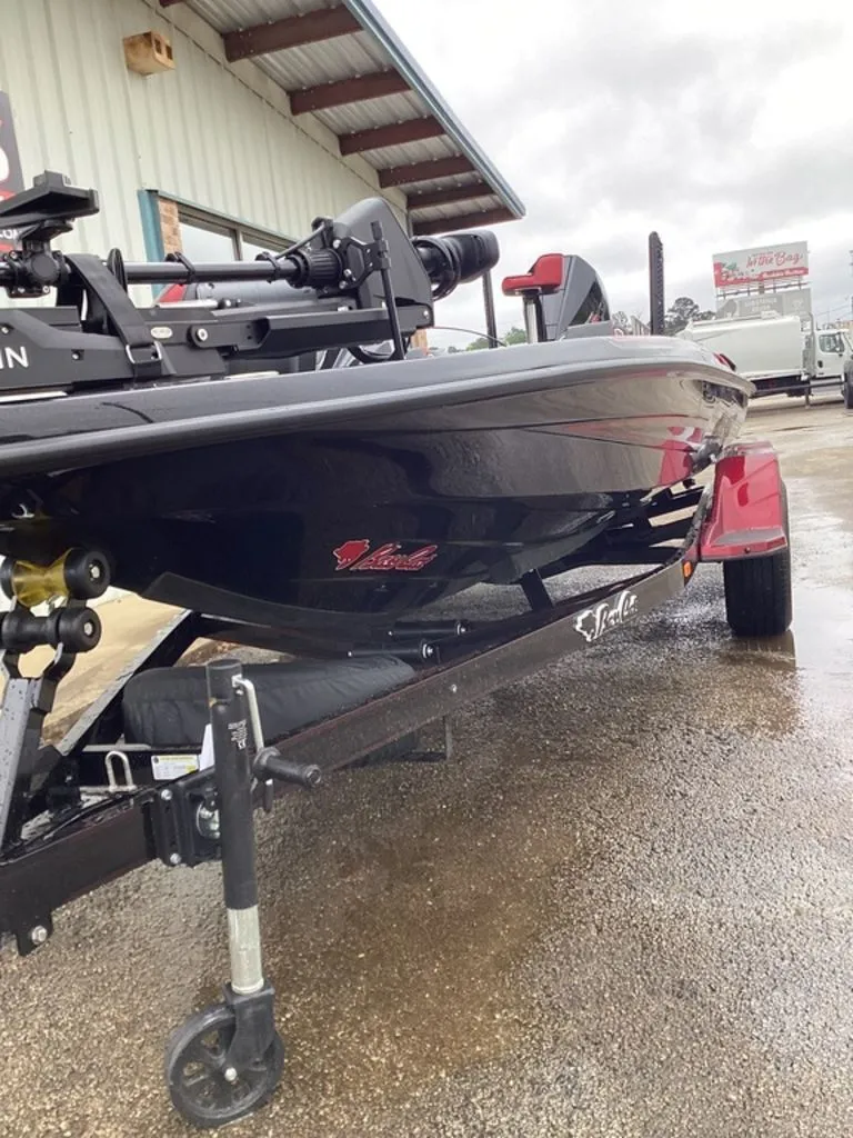Slide: The Image of 2026 Bass Cat Eyra SP boat on trailer, side view. - 11