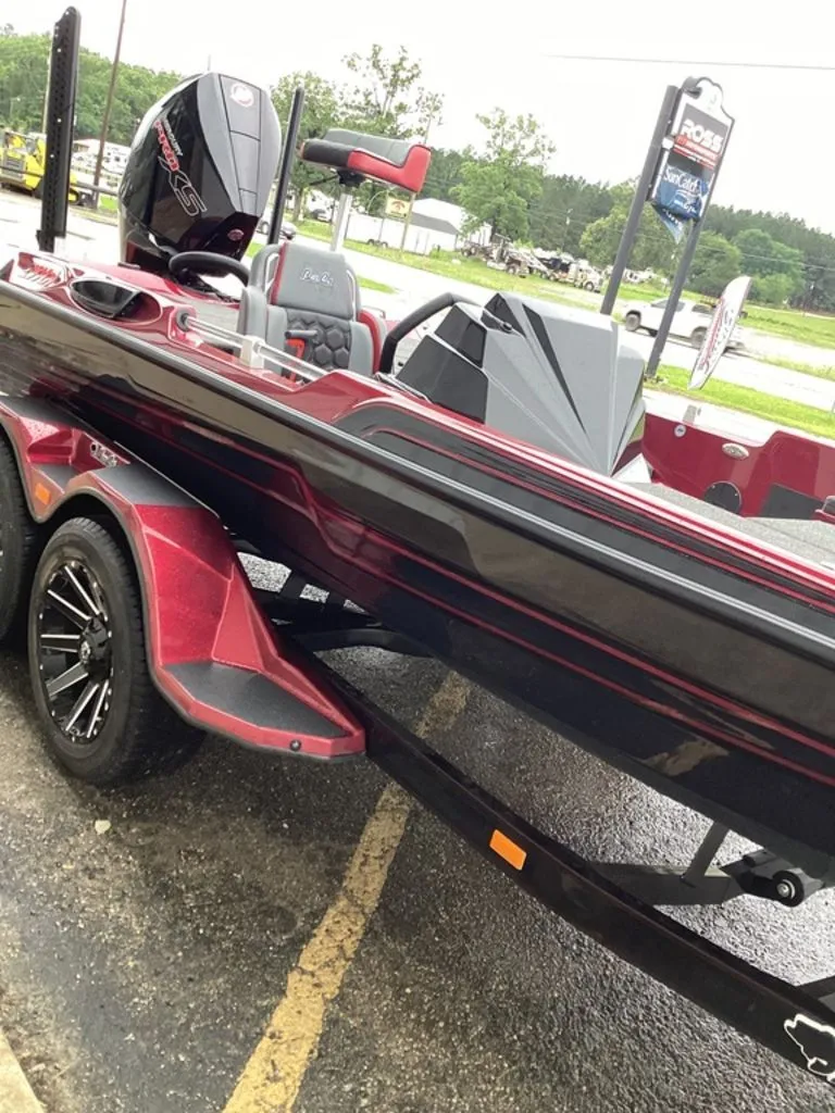 Slide: The Image of 2026 Bass Cat Eyra SP boat on trailer, red and black, parked outdoors. - 15