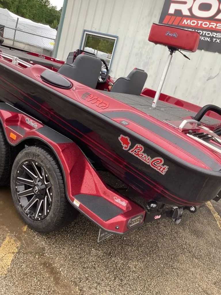 Slide: The Image of 2026 Bass Cat Eyra SP boat on trailer, red and black, side view. - 3