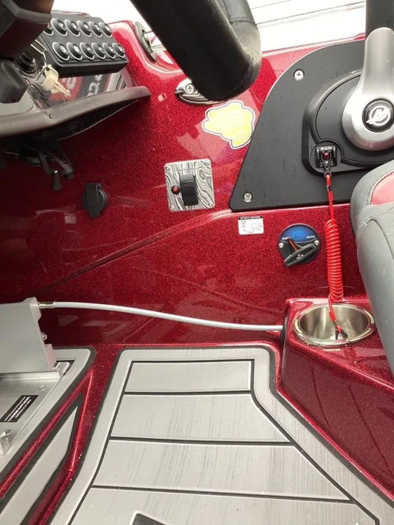 Slide: The Image of Interior view of 2026 Bass Cat Eyra SP boat, red console. - 36