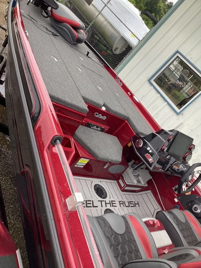 Slide: The Image of 2026 Bass Cat Eyra SP boat with gray seats and red design. - 9
