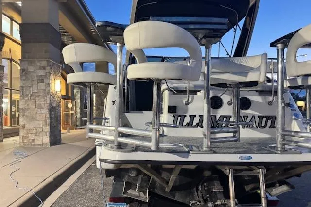 Slide: The Image of 1995 Maxum 2700 SR boat with custom seating, parked near a building at dusk. - 11