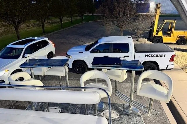 Slide: The Image of Outdoor seating area on a 1995 Maxum 2700 SR boat, parked near vehicles. - 14