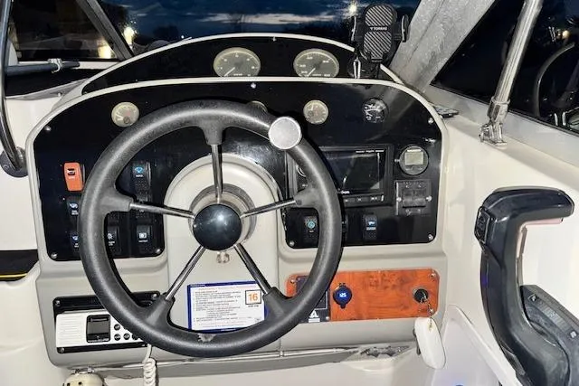 Slide: The Image of Steering console of a 1995 Maxum 2700 SR boat with gauges and controls. - 17