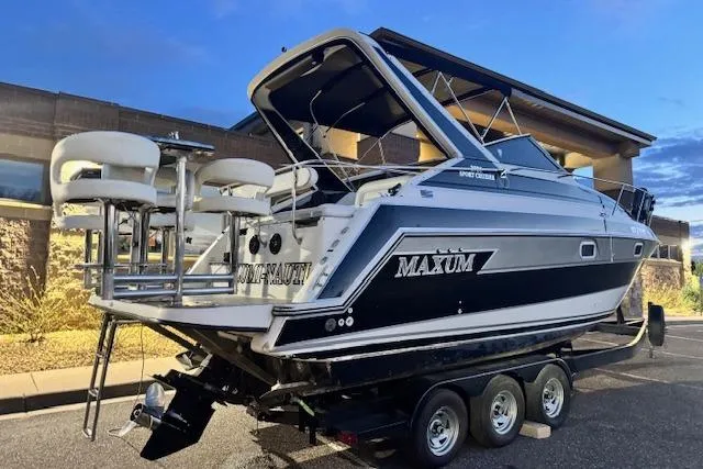 Slide: The Image of 1995 Maxum 2700 SR boat on trailer, featuring sleek design and outdoor seating. - 6