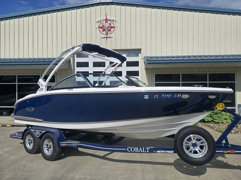 The Image of 2021 Cobalt CS22 boat on trailer in front of building. - 1