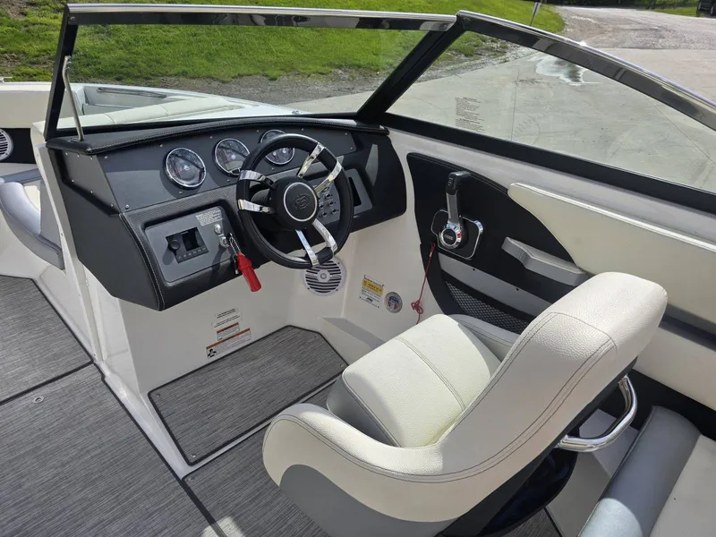 Slide: The Image of Interior of a 2021 Cobalt CS22 boat with steering wheel and seat. - 11