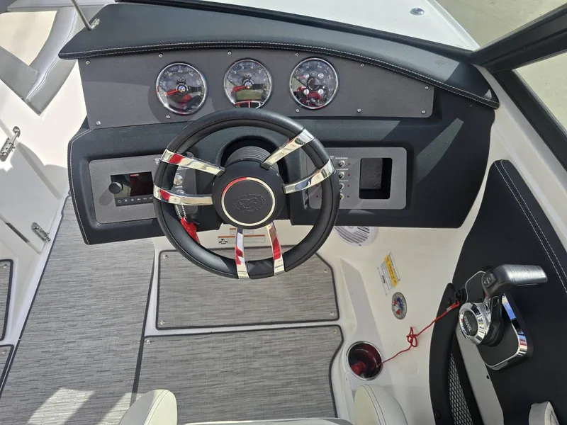 Slide: The Image of Interior view of 2021 Cobalt CS22 boat cockpit with steering wheel and gauges. - 12