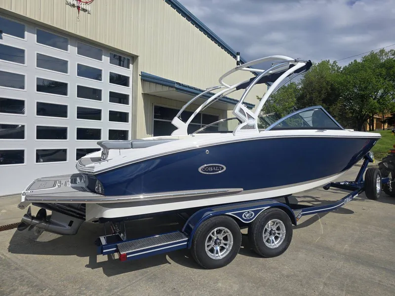 Slide: The Image of 2021 Cobalt CS22 boat on trailer in front of garage. - 3