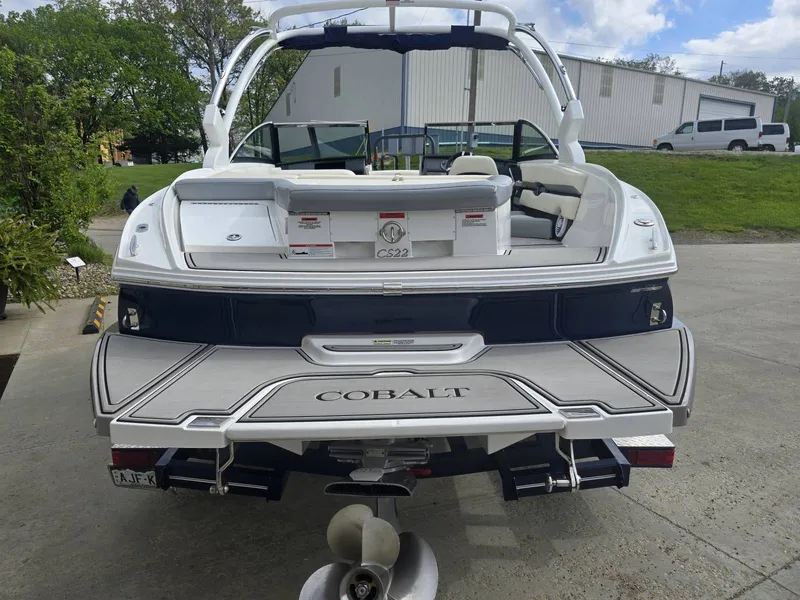 Slide: The Image of Rear view of a 2021 Cobalt CS22 boat in a parking area. - 4