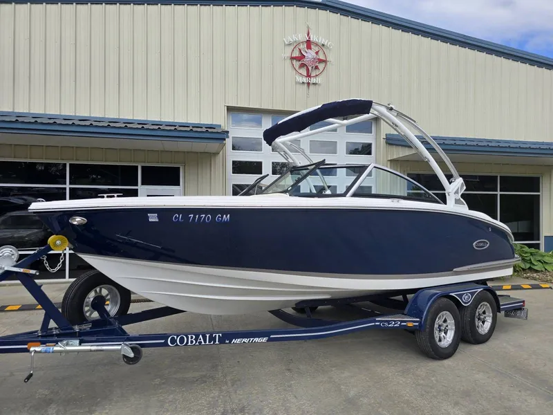 Slide: The Image of 2021 Cobalt CS22 boat on trailer in front of marine building. - 7