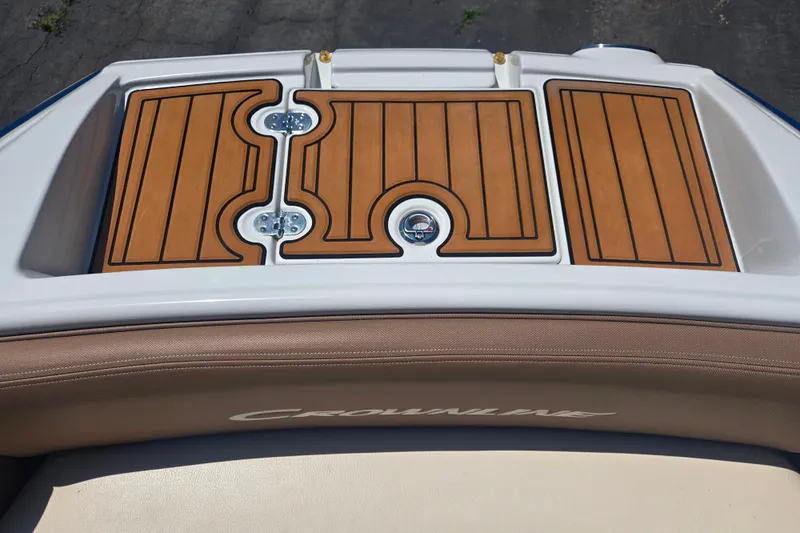 Slide: The Image of 2021 Crownline Eclipse E235 boat deck with teak-style flooring and cushioned seating. - 10