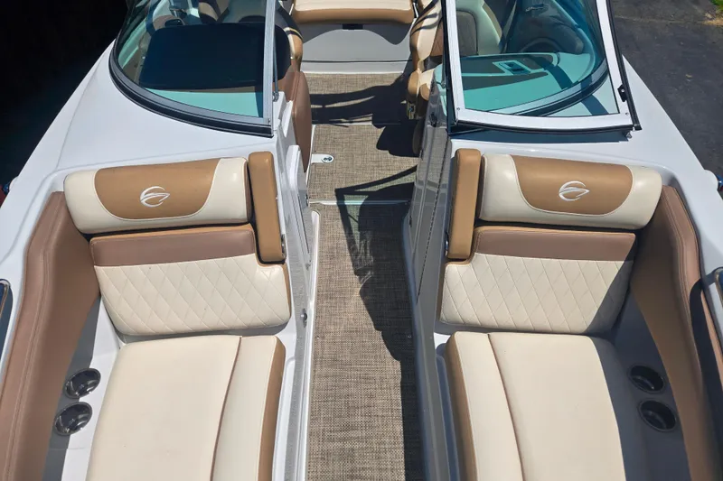 Slide: The Image of 2021 Crownline Eclipse E235 boat interior with tan and cream seating. - 11