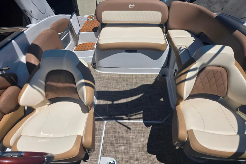 Slide: The Image of Interior of 2021 Crownline Eclipse E235 boat with beige and brown seating. - 12