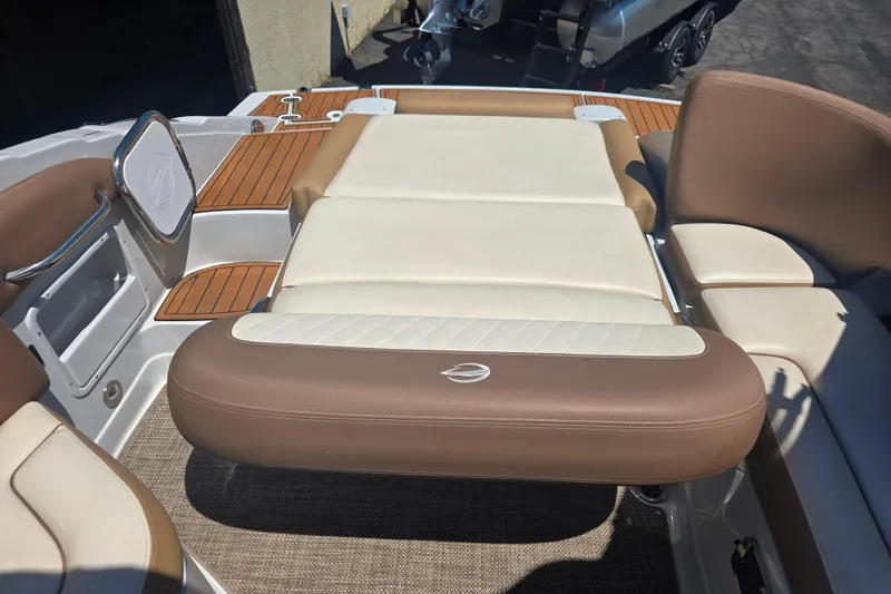 Slide: The Image of 2021 Crownline Eclipse E235 boat interior with tan and white seating. - 19