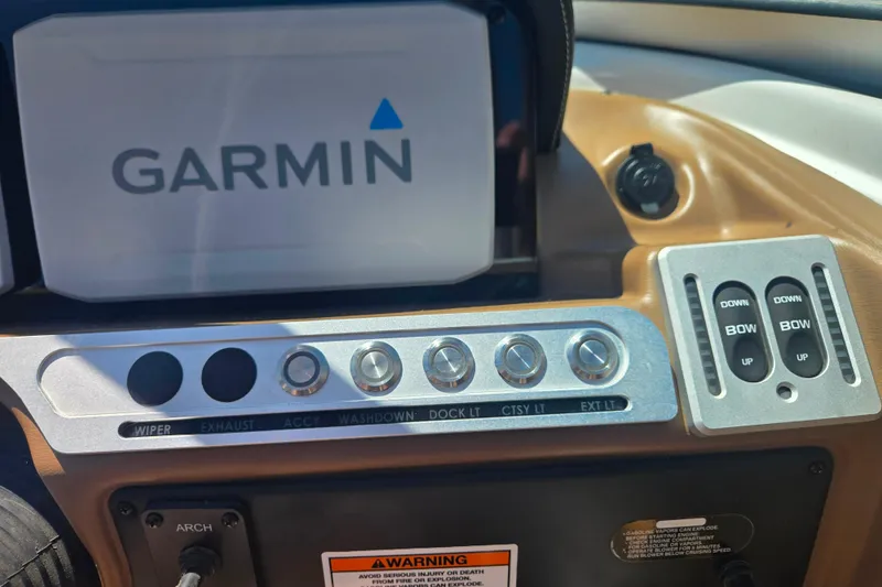 Slide: The Image of Dashboard of 2021 Crownline Eclipse E235 with Garmin display and control switches. - 23