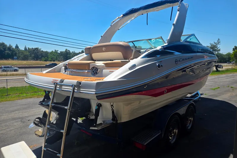 Slide: The Image of 2021 Crownline Eclipse E235 boat on trailer, featuring sleek design and swim platform. - 3