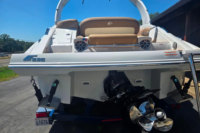 Slide: The Image of 2021 Crownline Eclipse E235 boat rear view with propeller and seating area. - 4