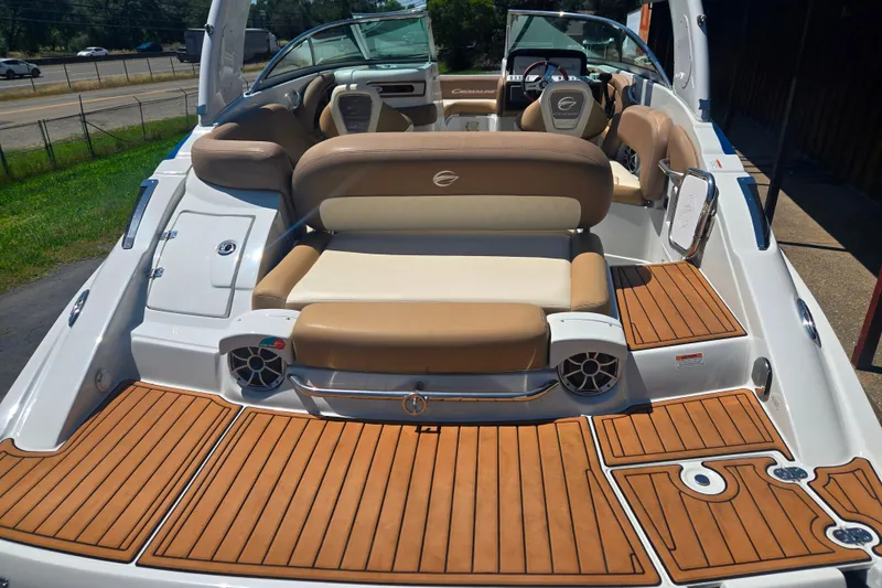 Slide: The Image of 2021 Crownline Eclipse E235 boat with luxurious seating and teak-style flooring. - 6