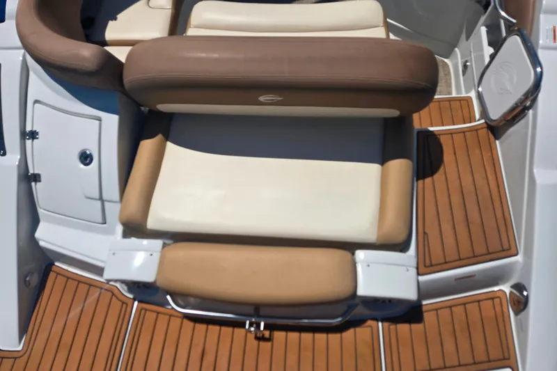 Slide: The Image of 2021 Crownline Eclipse E235 boat interior with brown and cream seating, teak flooring. - 8