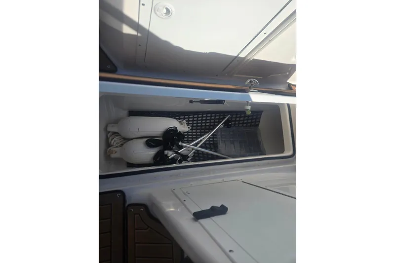 Slide: The Image of Storage compartment of 2022 Yamaha Boats 212SD with boating accessories. - 13