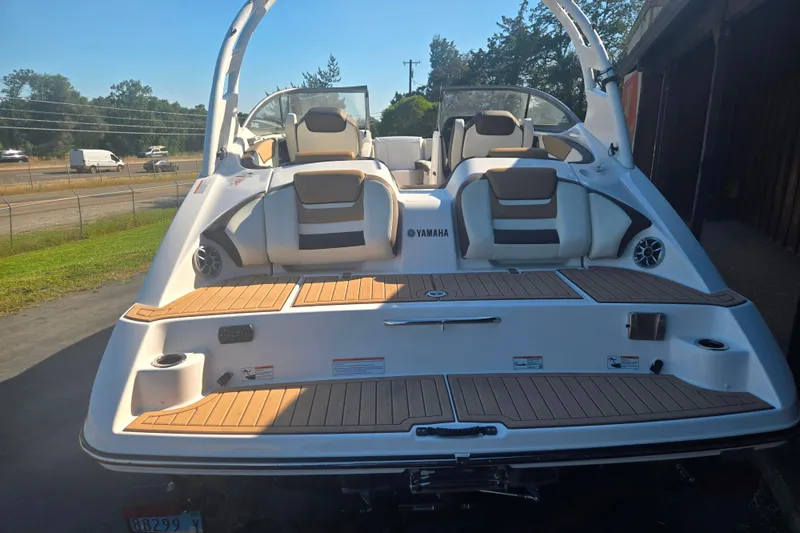 Slide: The Image of 2022 Yamaha Boats 212SD, rear view, showcasing seating and deck design. - 4