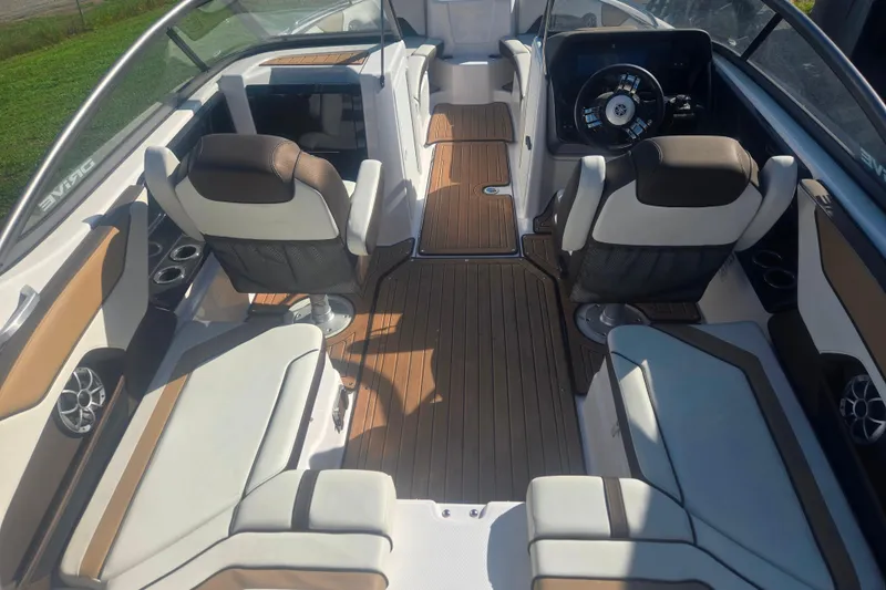 Slide: The Image of 2022 Yamaha Boats 212SD interior with sleek seating and modern dashboard design. - 6
