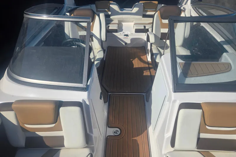 Slide: The Image of Interior view of 2022 Yamaha Boats 212SD, featuring sleek seating and wood-style flooring. - 8