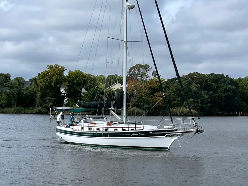 Slide: The Image of Sailing yacht Gozzard 44 AC, 1996 model, cruising on a calm river. - 1