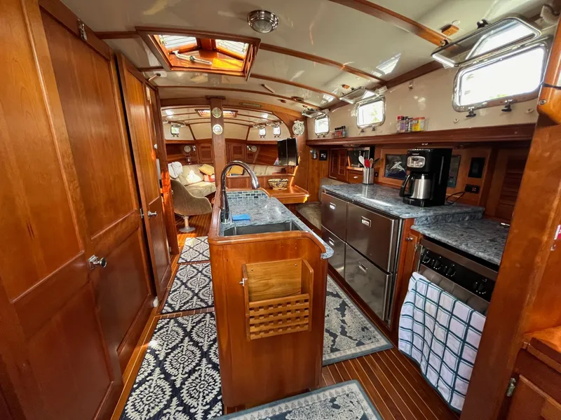 Slide: The Image of Luxurious 1996 Gozzard 44 AC yacht interior with wood finish and modern amenities. - 11