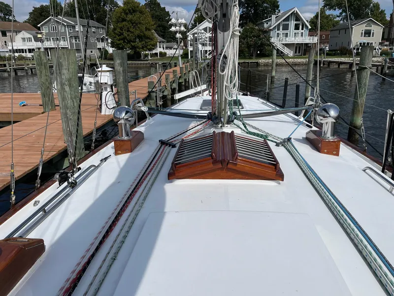 Slide: The Image of Gozzard 44 AC sailboat deck, 1996 model, docked in a marina with waterfront homes. - 6