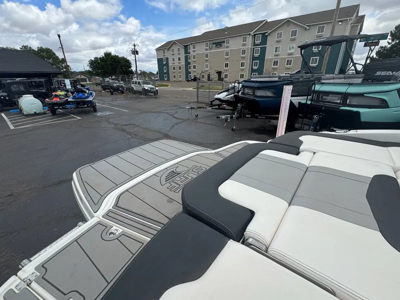 Slide: The Image of Chaparral Surf 21 boat 2021 on parking lot with buildings in background. - 10