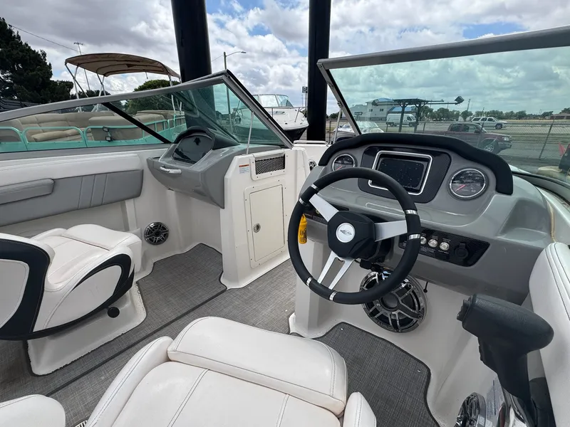 Slide: The Image of Interior of a 2021 Chaparral Surf 21 boat with steering console. - 11