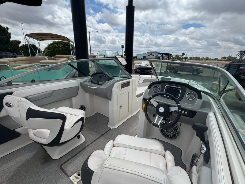 Slide: The Image of Interior of a 2021 Chaparral Surf 21 boat with steering console. - 12