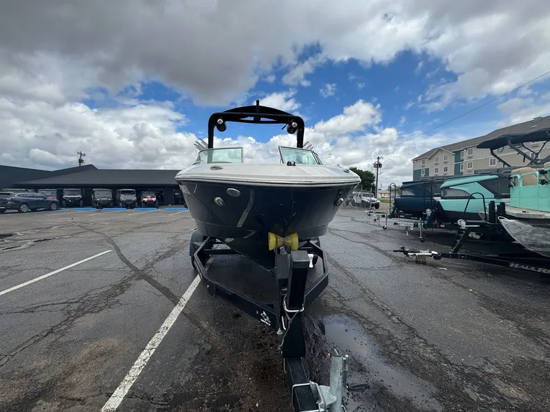 Slide: The Image of 2021 Chaparral Surf 21 boat on trailer under cloudy sky. - 4