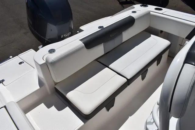 Slide: The Image of 2023 Robalo R202 Explorer boat with white seating area. - 22
