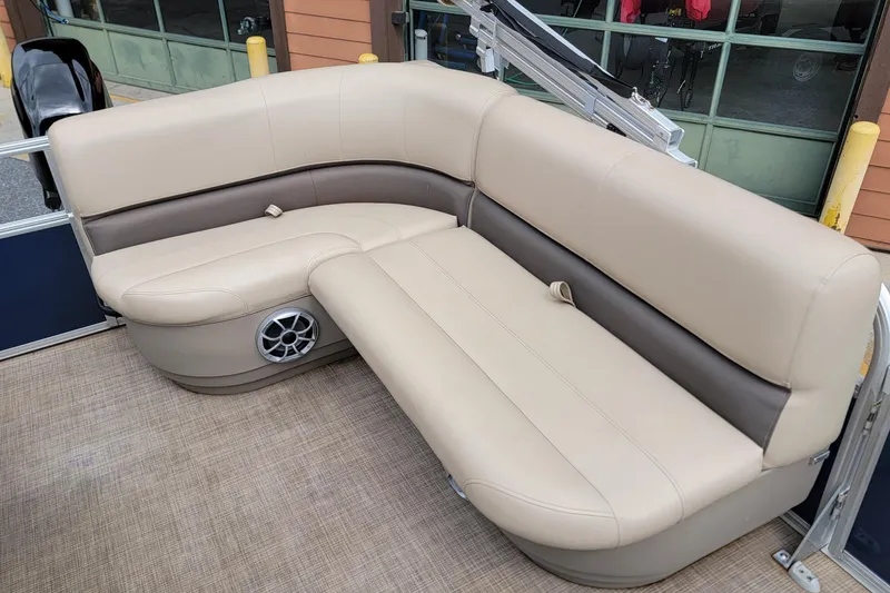 Slide: The Image of 2024 Sun Tracker Bass Buggy 16 XL Select pontoon boat seating, beige upholstery, and integrated speaker. - 10