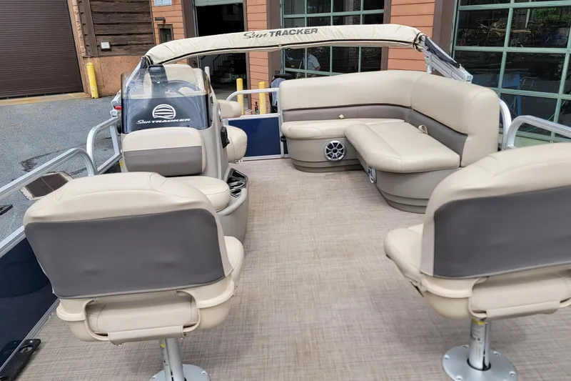 Slide: The Image of 2024 Sun Tracker Bass Buggy 16 XL Select pontoon boat interior with beige seating. - 4