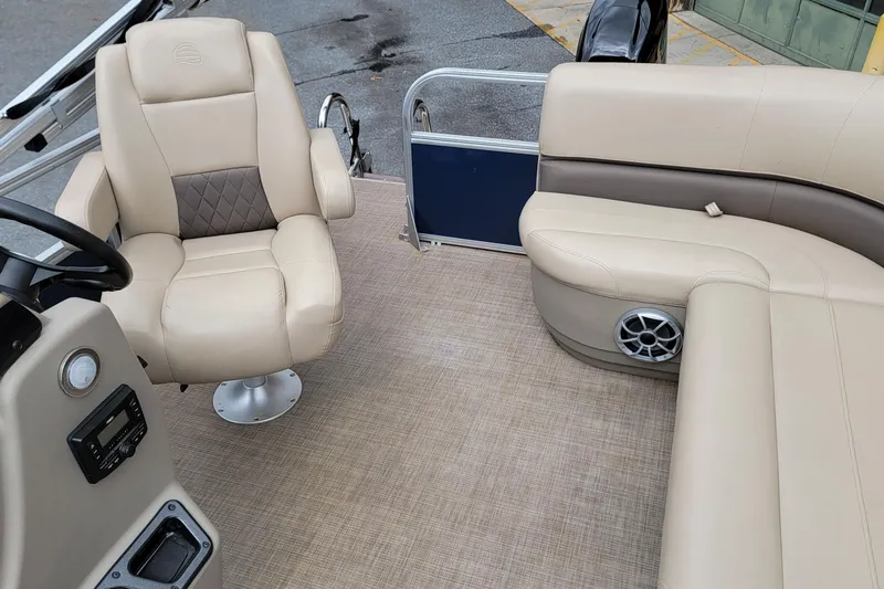 Slide: The Image of 2024 Sun Tracker Bass Buggy 16 XL Select interior with beige seating and steering console. - 5