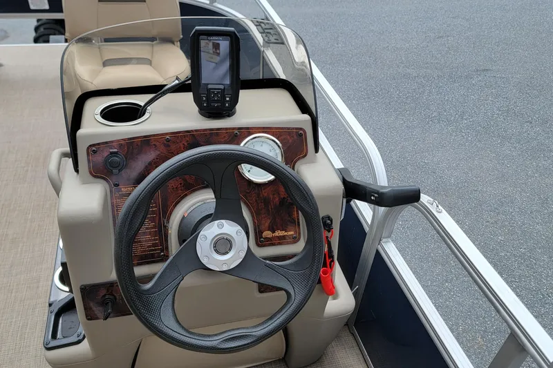 Slide: The Image of 2024 Sun Tracker Bass Buggy 16 XL Select steering console with GPS and cup holder. - 6