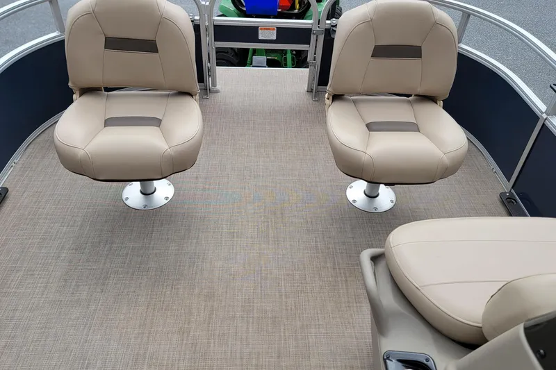 Slide: The Image of 2024 Sun Tracker Bass Buggy 16 XL Select interior with beige seating and spacious deck. - 8
