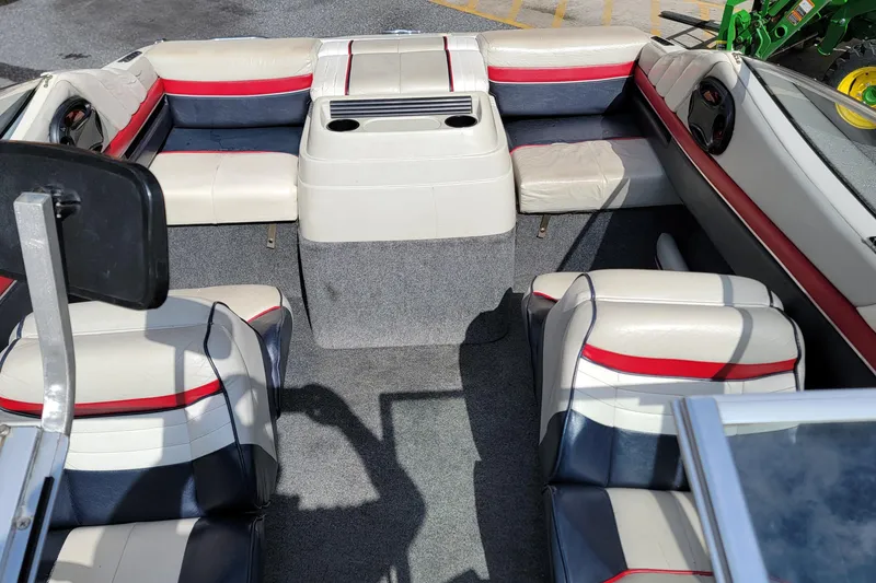 Slide: The Image of Interior of a 1990 Bayliner 1850 Capri boat with white and red seating. - 10