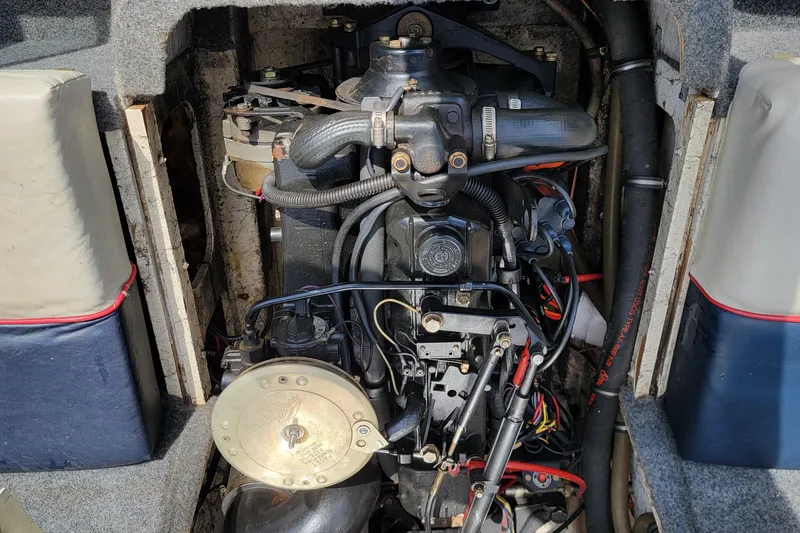 Slide: The Image of Engine compartment of a 1990 Bayliner 1850 Capri boat, showing detailed mechanical components. - 11