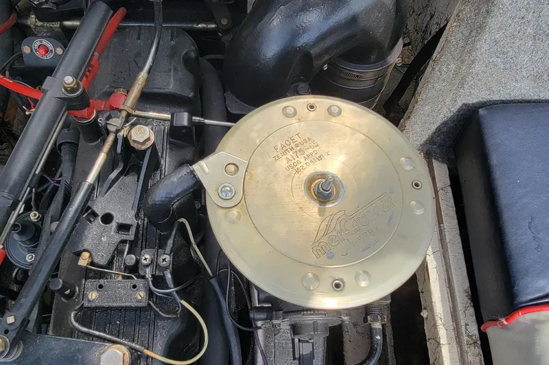 Slide: The Image of Engine compartment of a 1990 Bayliner 1850 Capri boat, featuring a MerCruiser component. - 12