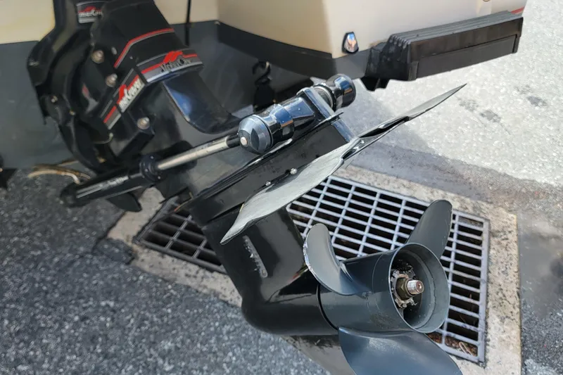 Slide: The Image of 1990 Bayliner 1850 Capri boat motor and propeller detail on pavement. - 13